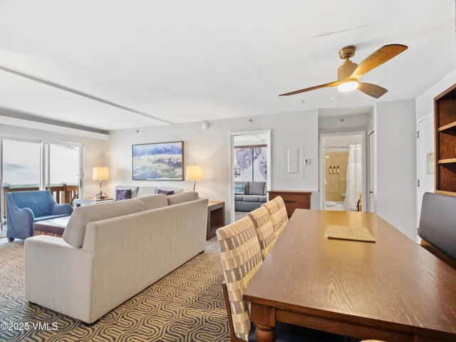 a living room with furniture and a dining table