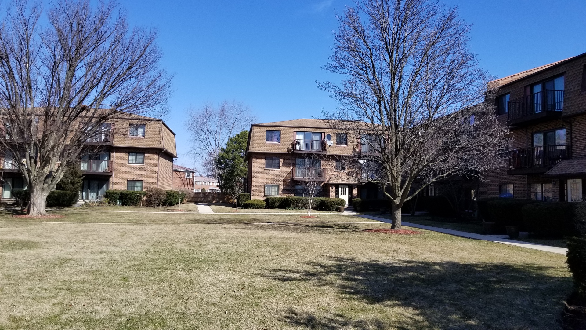 a front view of a building with a yard