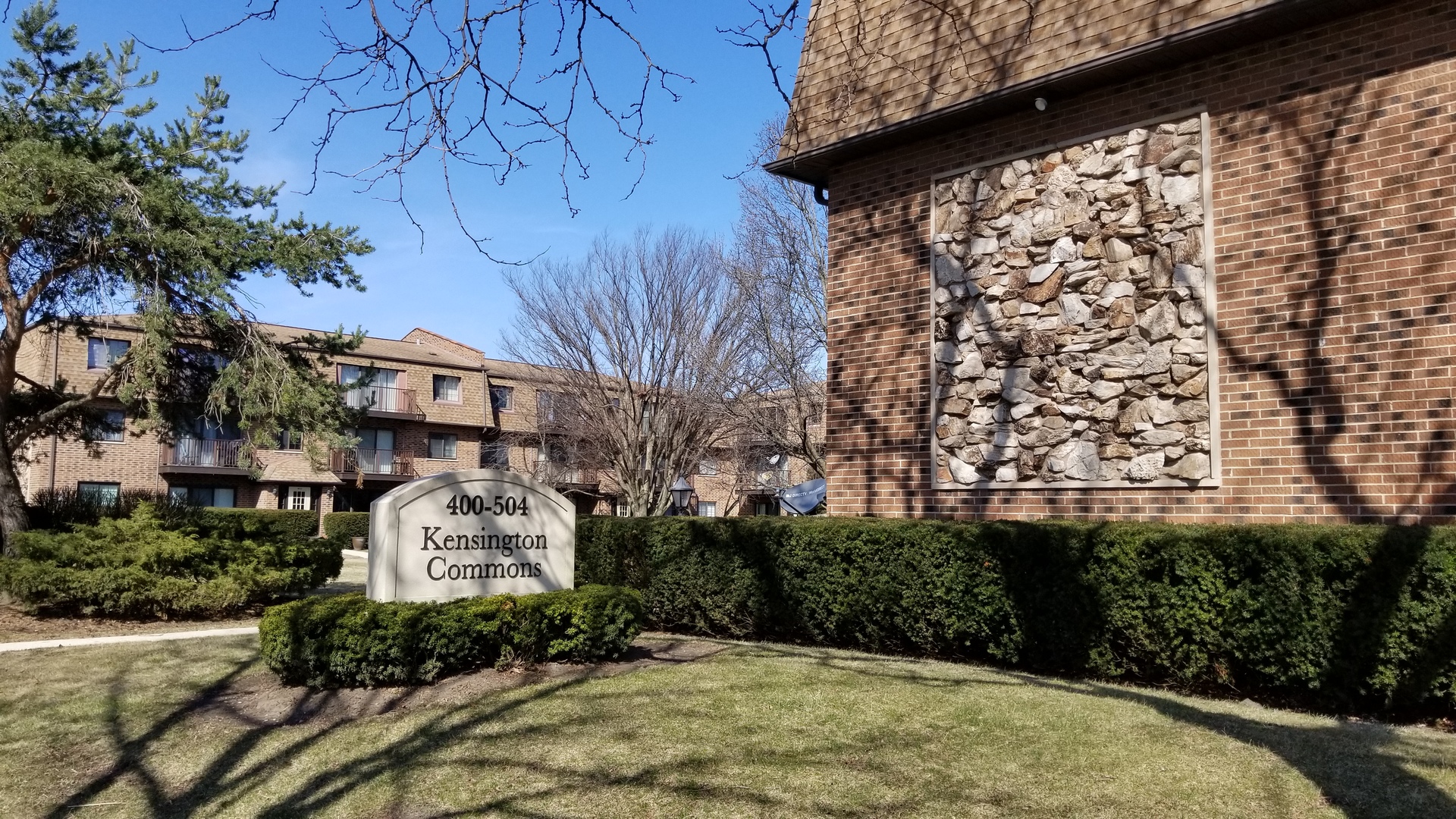 406 East Kensington Road, Unit C Mount Prospect, IL 60056 - Photo 2 of 22 a front view of a house with a yard