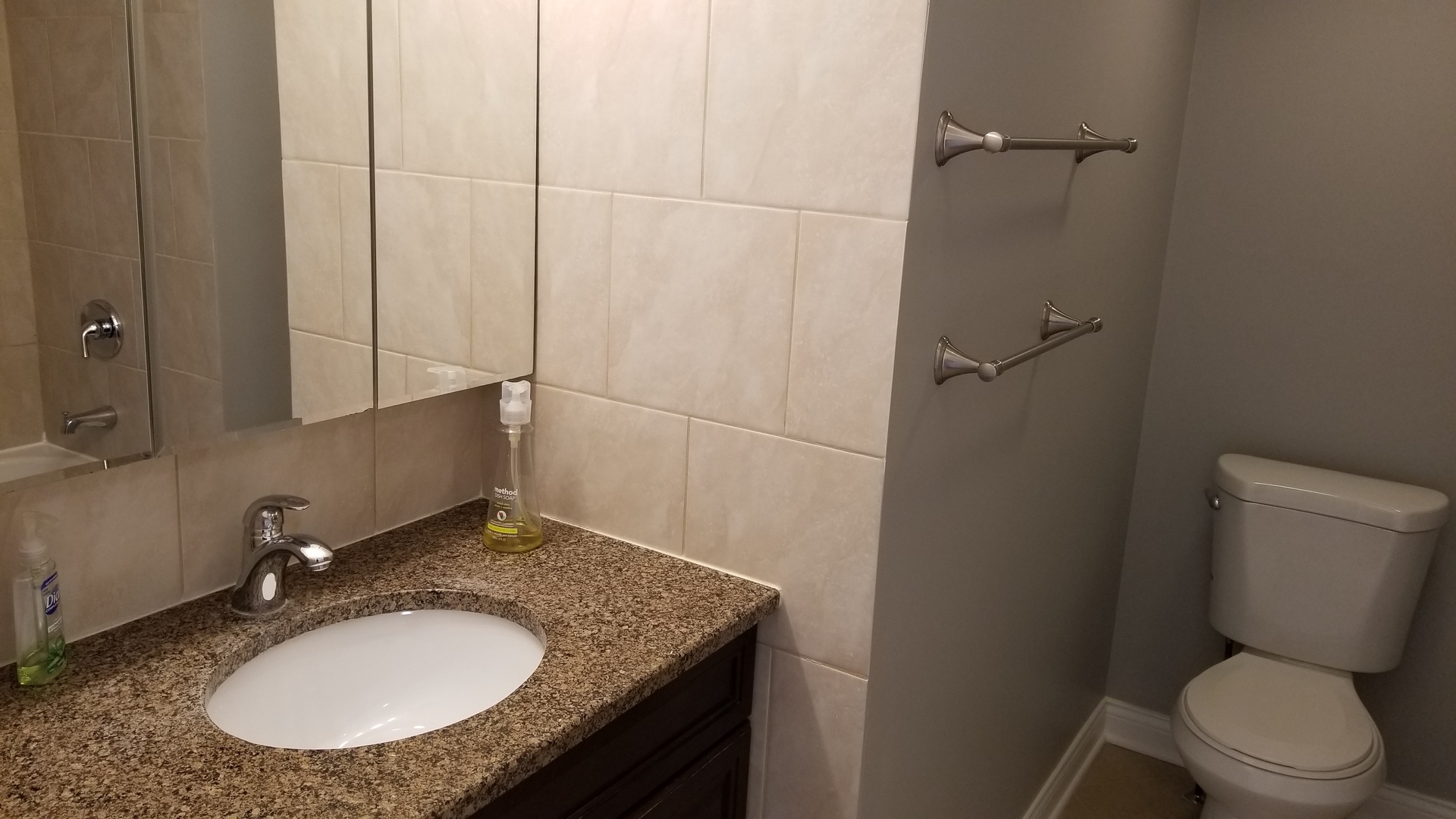 406 East Kensington Road, Unit C Mount Prospect, IL 60056 - Photo 17 of 22 a bathroom with a granite countertop toilet sink and mirror