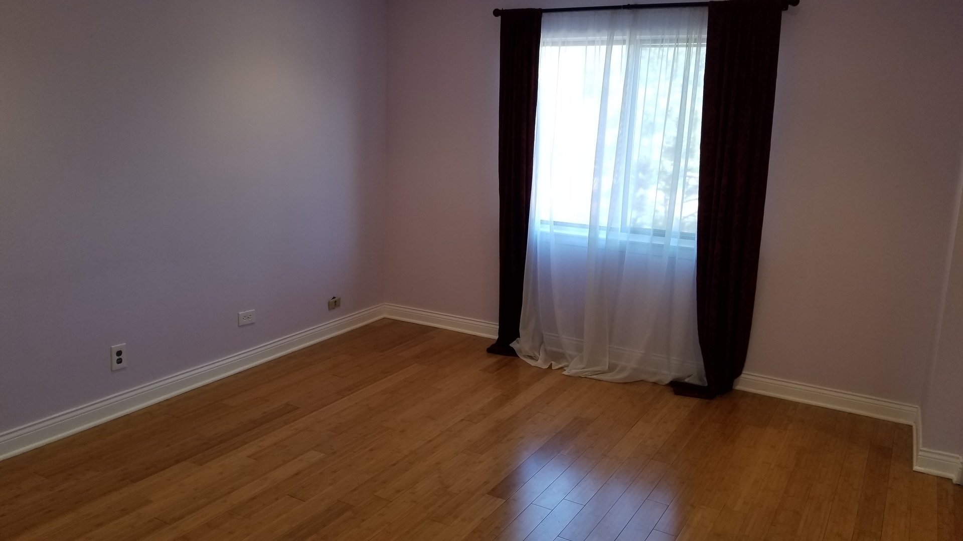 406 East Kensington Road, Unit C Mount Prospect, IL 60056 - Photo 20 of 22 an empty room with wooden floor and windows