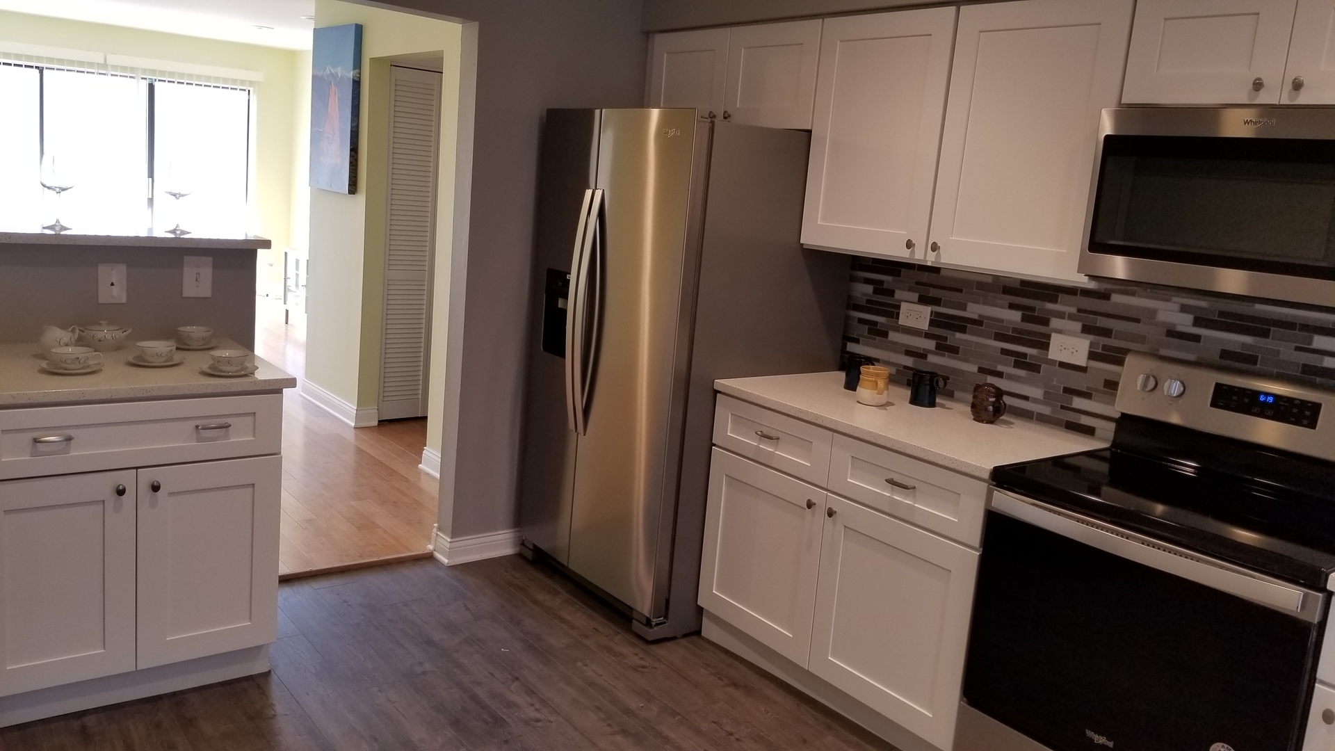 406 East Kensington Road, Unit C Mount Prospect, IL 60056 - Photo 3 of 22 a kitchen with white cabinets and black appliances