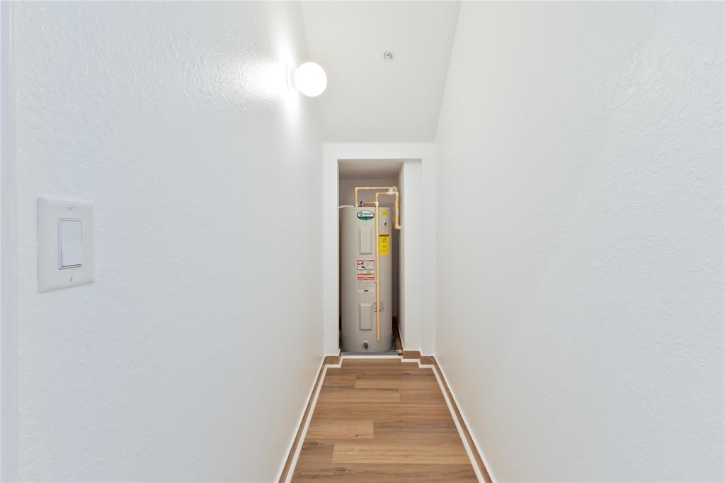 122 Southwest 7th Court, Unit 122 Pompano Beach, FL 33060 - Photo 20 of 36 a view of a hallway with wooden floor and a bathroom