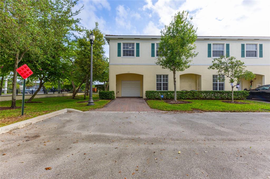 122 Southwest 7th Court, Unit 122 Pompano Beach, FL 33060 - Photo 29 of 36 a view of a house with a backyard and a tree