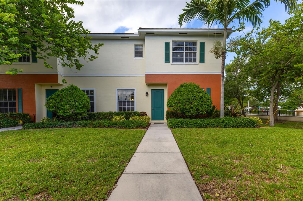 122 Southwest 7th Court, Unit 122 Pompano Beach, FL 33060 - Photo 33 of 36 front view of a house with a yard