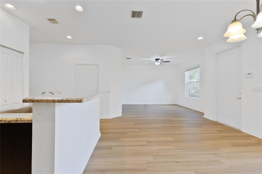 122 Southwest 7th Court, Unit 122 Pompano Beach, FL 33060 - Photo 6 of 36 a view of empty room with wooden floor
