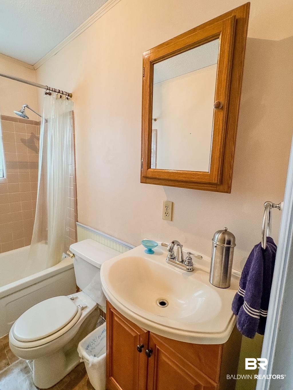 1456 Allen Walker Road Grove Hill, AL 36451 - Photo 27 of 28 Bathroom featuring vanity, shower / bathtub combination with curtain, and ornamental molding
