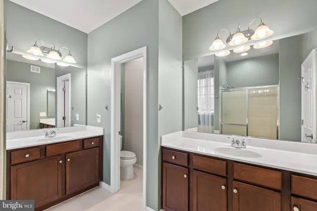 a bathroom with a double vanity sink and a mirror