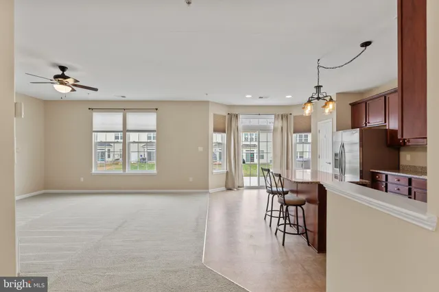 a living room with furniture a flat screen tv and a large window