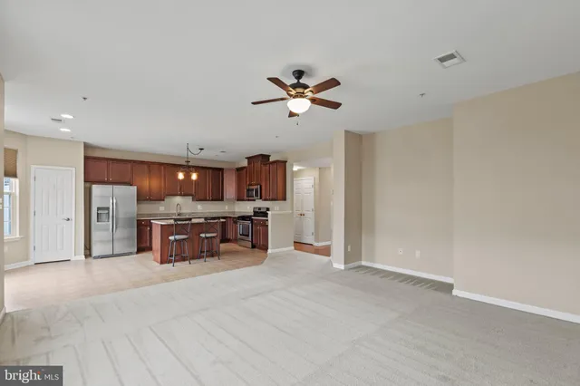 a view of kitchen with furniture and a refrigerator
