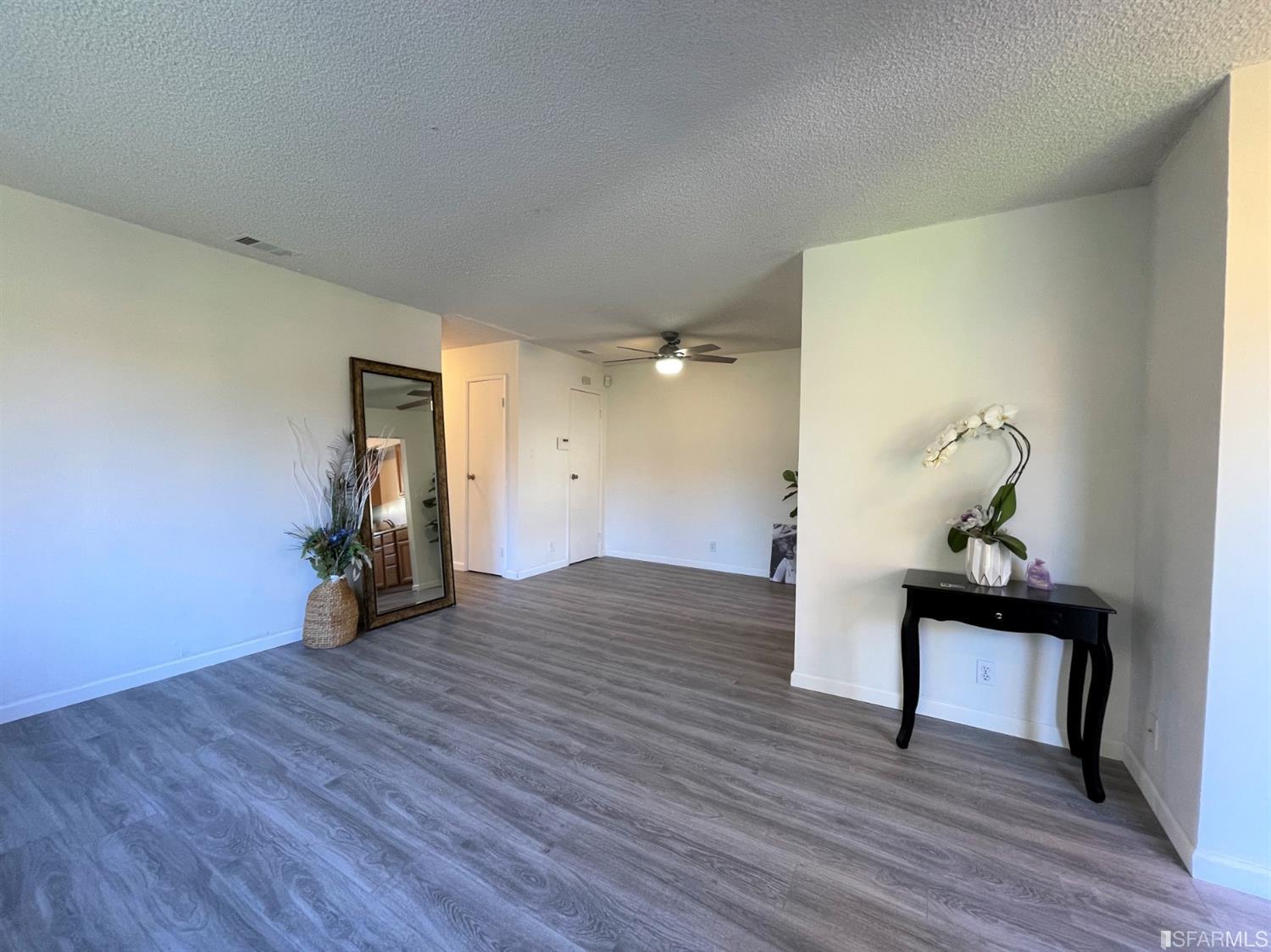 1493 Del Rio Circle, Unit D Concord, CA 94518 - Photo 4 of 23 a view of empty room with wooden floor