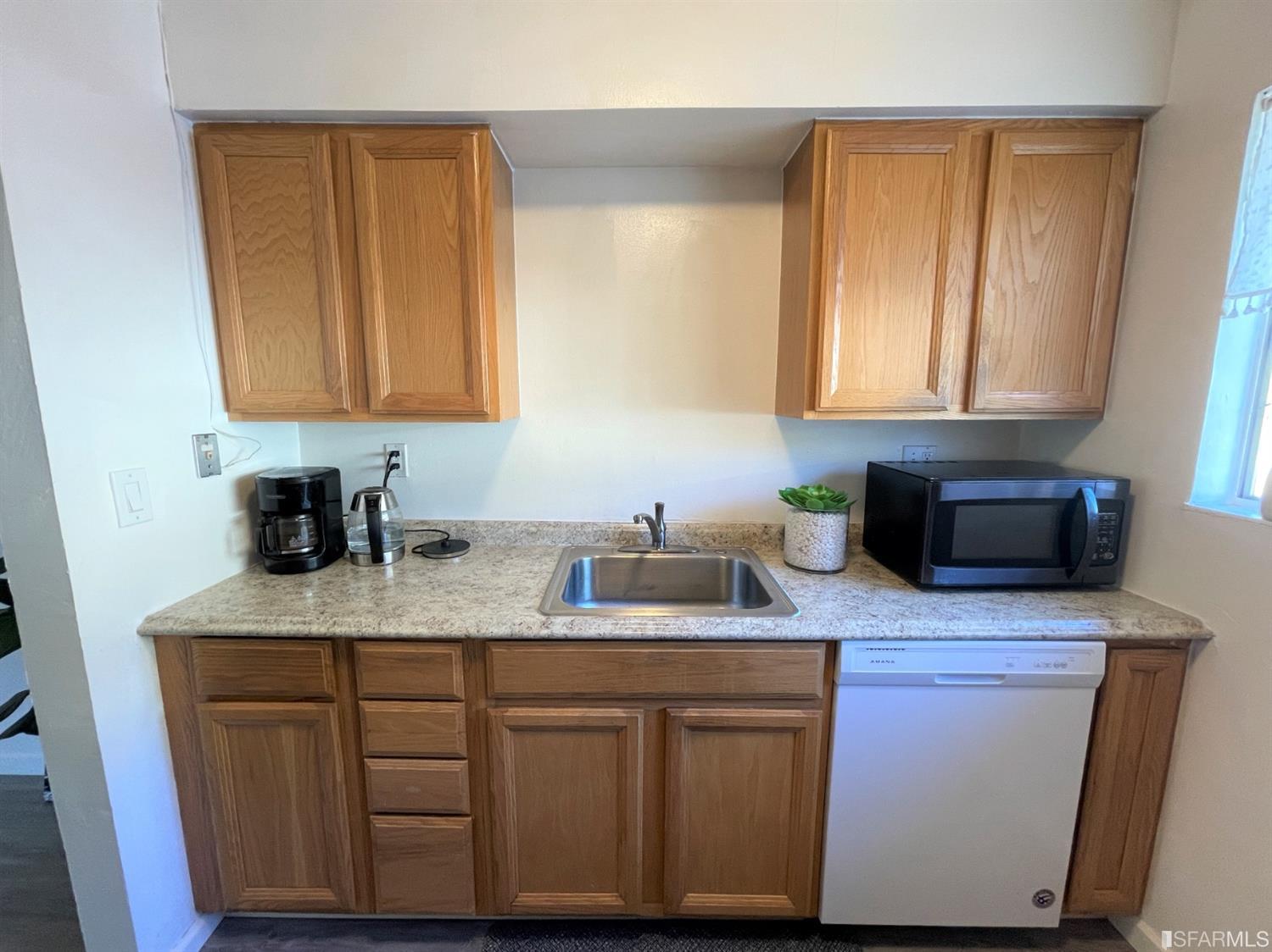 1493 Del Rio Circle, Unit D Concord, CA 94518 - Photo 8 of 23 a kitchen with stainless steel appliances granite countertop a sink stove and cabinets