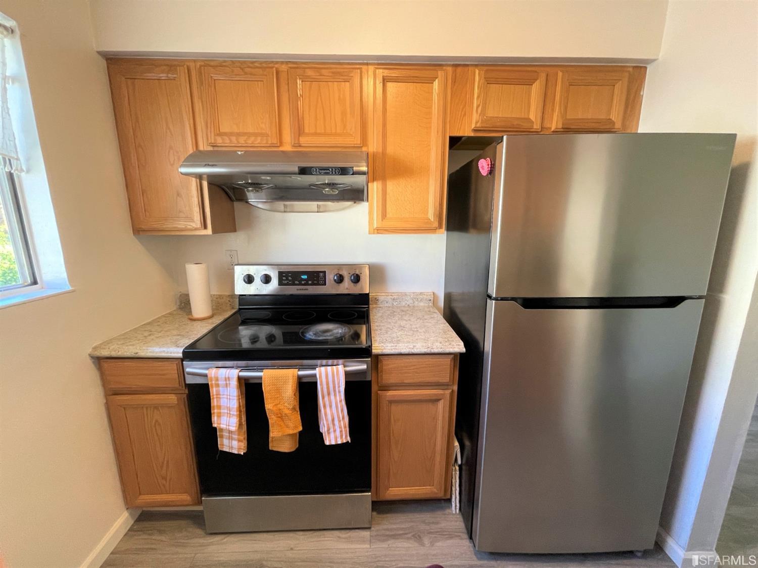 1493 Del Rio Circle, Unit D Concord, CA 94518 - Photo 9 of 23 a kitchen with stainless steel appliances granite countertop a refrigerator and a stove