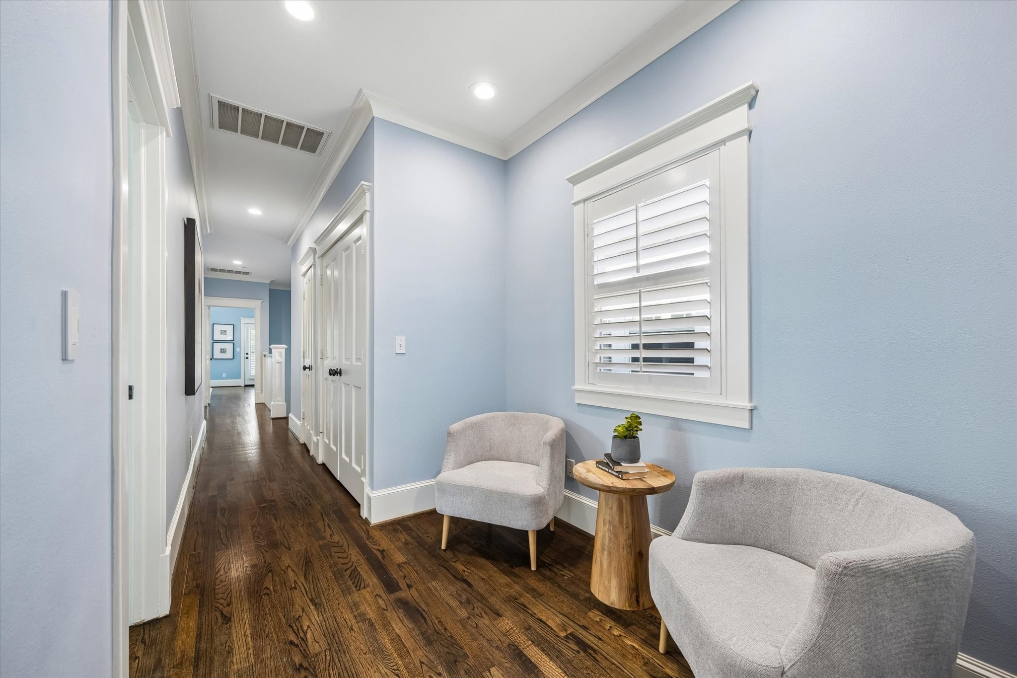 634 West 17th Street Houston, TX 77008 - Photo 25 of 42 The upstairs landing offers a cozy spot to pause, read, or simply catch your breath, with wood flooring, recessed lighting, rich millwork, and a wood shuttered window adding classic Heights character.