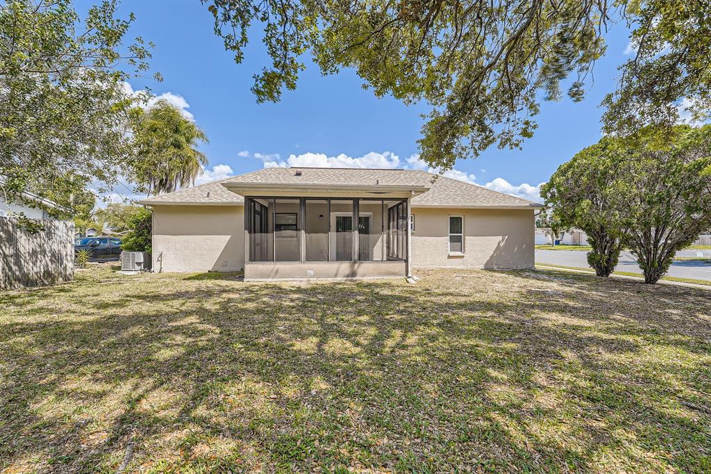 7001 Heath Drive Port Richey, FL 34668 - Photo 11 of 11 a front view of a house with a garden