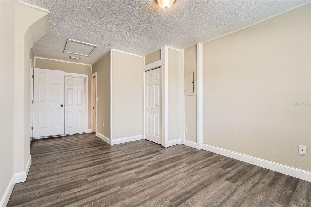 7001 Heath Drive Port Richey, FL 34668 - Photo 6 of 11 a view of an empty room with wooden floor and a window