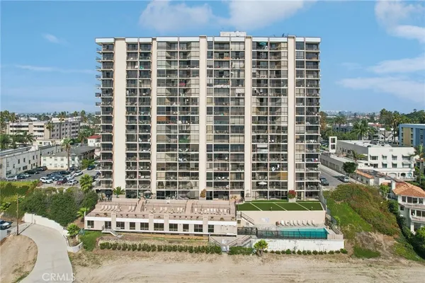 a front view of a building with a garden