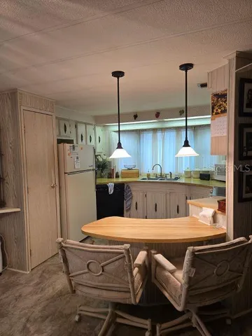 a view of a dining room with furniture and chandelier