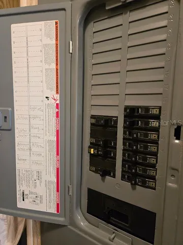 a room with water heater and storage racks