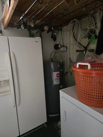 a kitchen with stainless steel appliances granite countertop a sink and a refrigerator