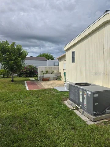 a backyard of a house with table and chairs
