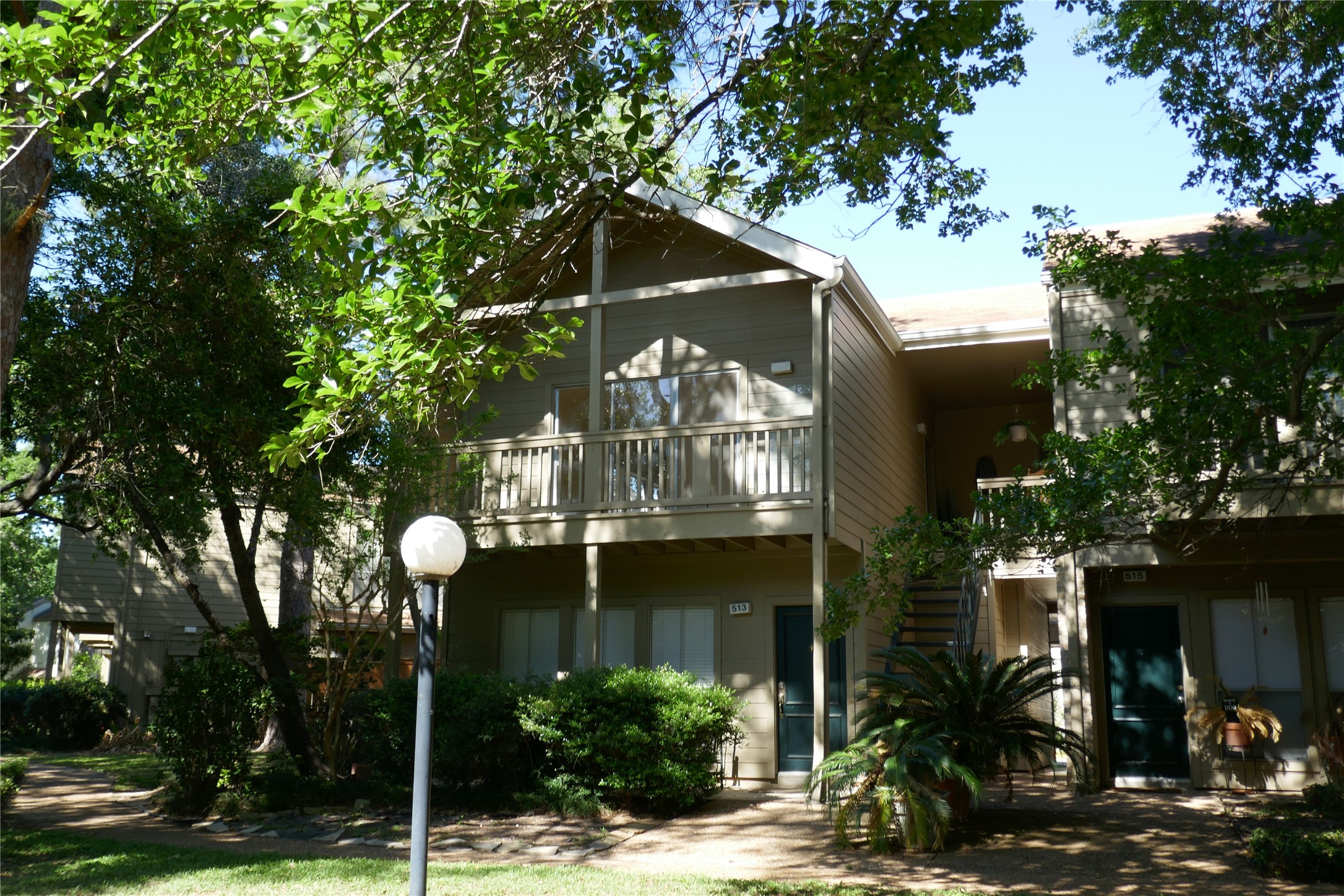 2100 Tanglewilde Street, Unit 514 Houston, TX 77063 - Photo 2 of 22 a front view of a house with a yard