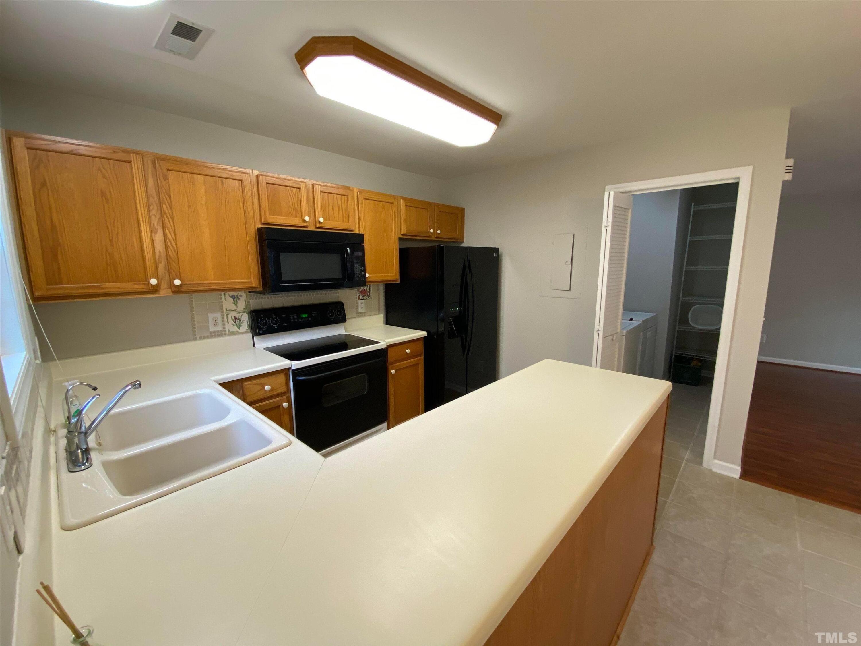2413 Wellington Ridge Loop, Unit 2413 Cary, NC 27518 - Photo 12 of 30 a kitchen with a refrigerator sink and microwave
