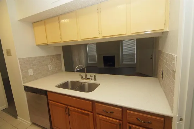 a kitchen with a sink and cabinets
