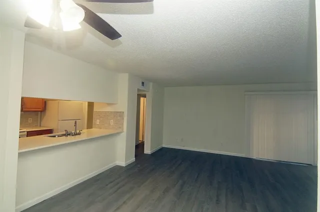 a view of a kitchen with a sink and wooden floor