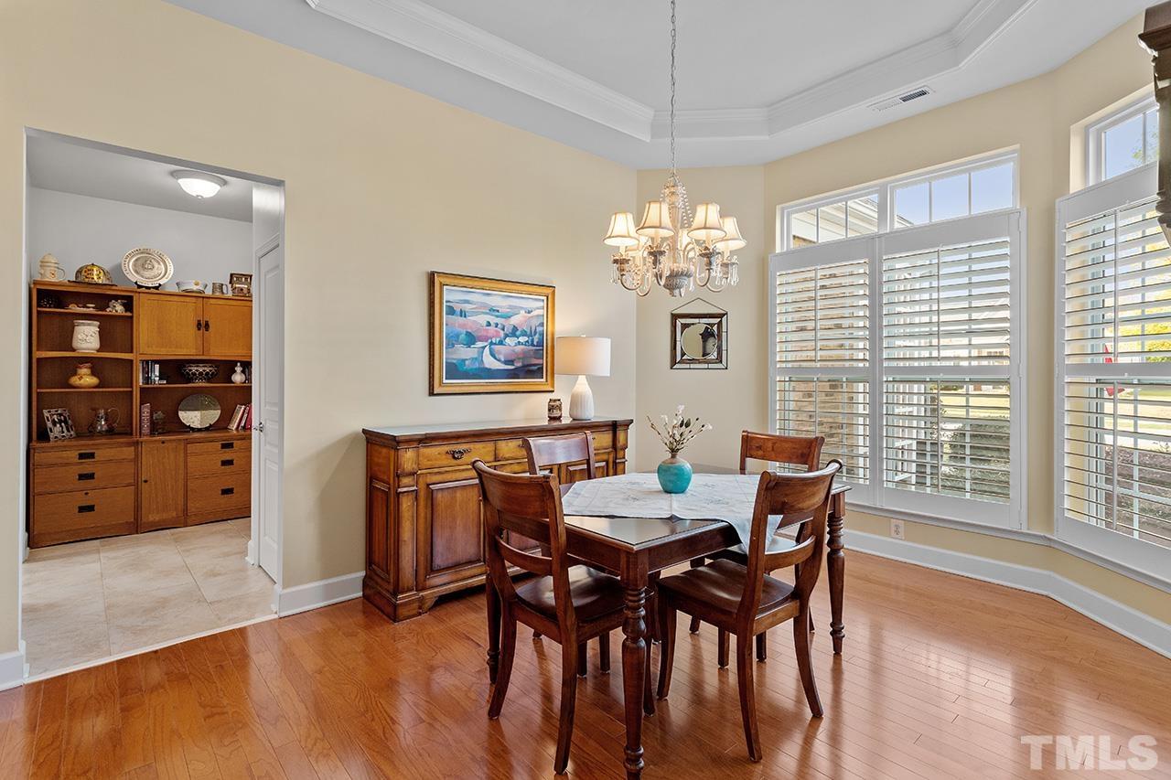 113 Beckingham Loop Cary, NC 27519 - Photo 11 of 46 a view of a dining room with furniture window and wooden floor