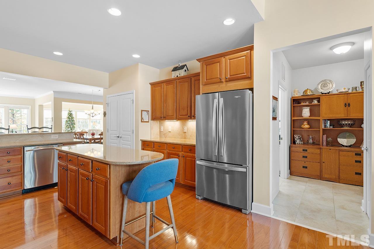 113 Beckingham Loop Cary, NC 27519 - Photo 13 of 46 a kitchen with stainless steel appliances granite countertop a refrigerator a sink and a stove