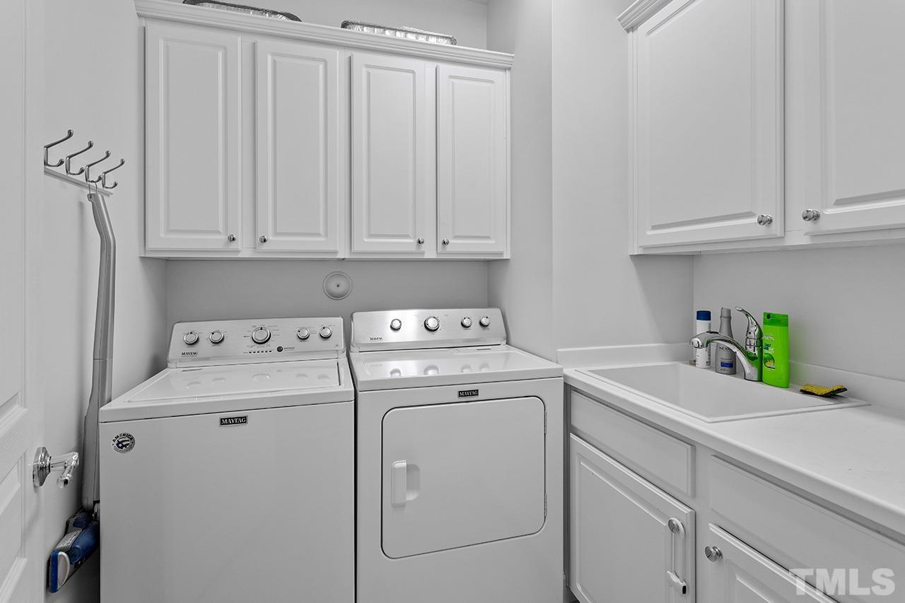 113 Beckingham Loop Cary, NC 27519 - Photo 16 of 46 a utility room with dryer and washer
