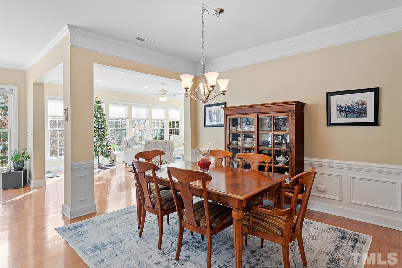113 Beckingham Loop Cary, NC 27519 - Photo 21 of 46 a dining room with furniture wooden floor and a chandelier