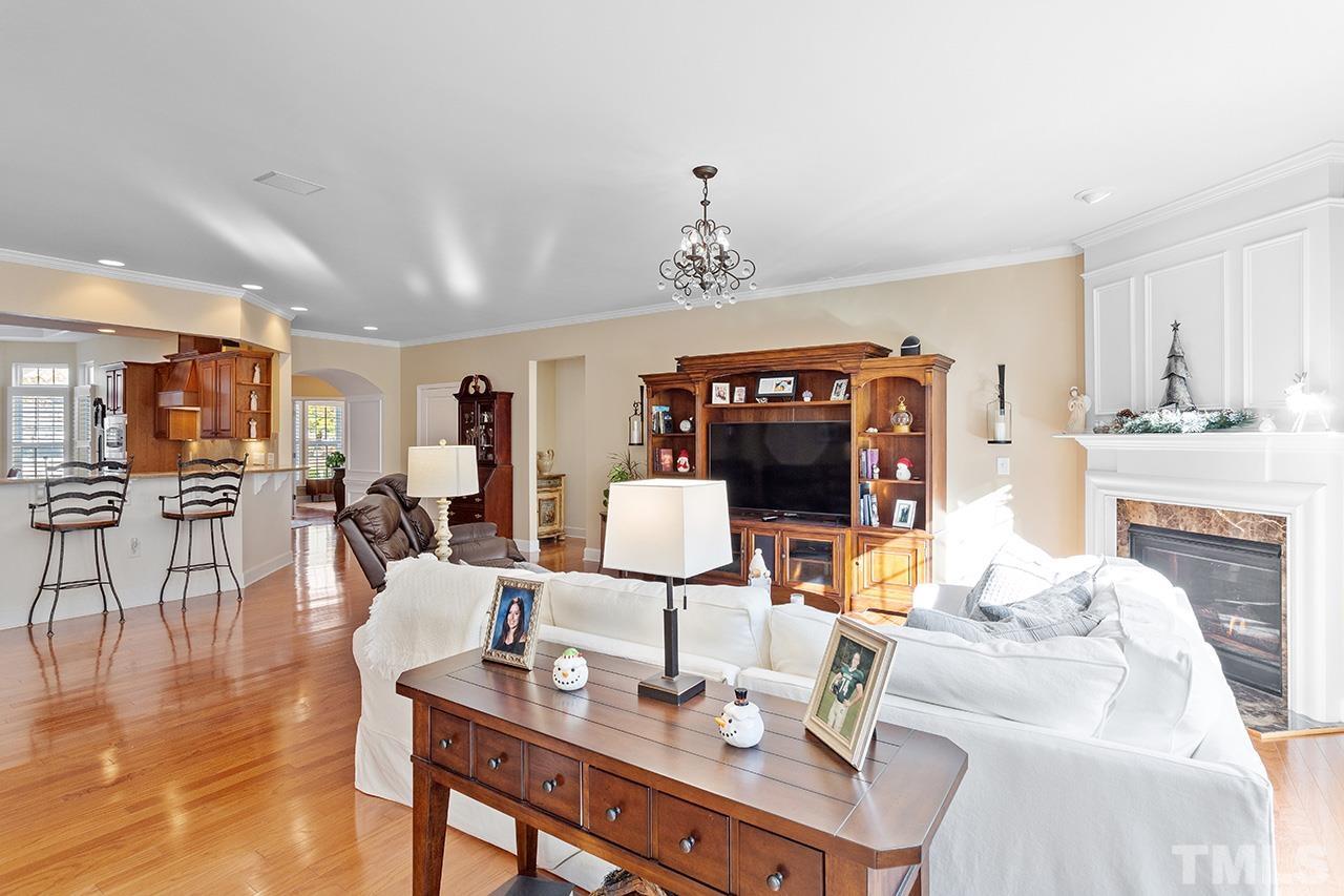 113 Beckingham Loop Cary, NC 27519 - Photo 25 of 46 a living room with fireplace furniture and a wooden floor