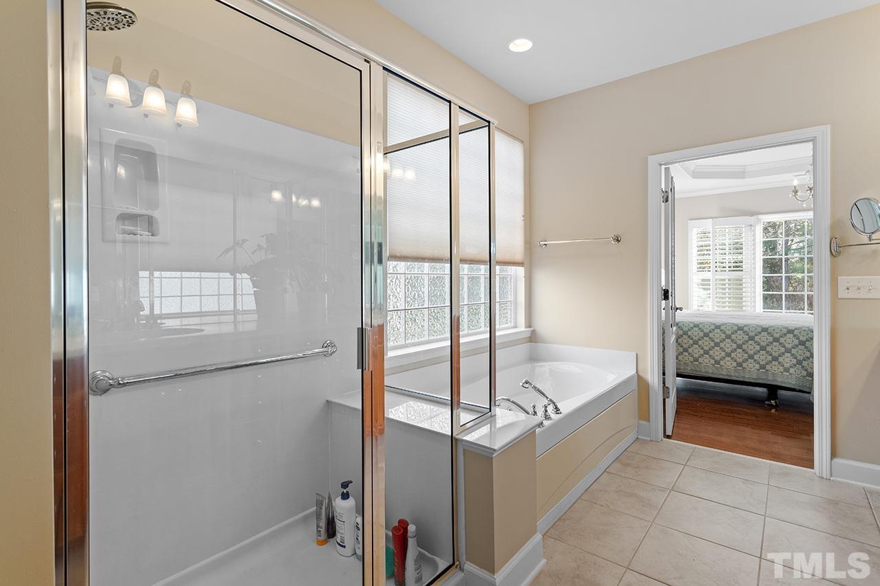 113 Beckingham Loop Cary, NC 27519 - Photo 29 of 46 a bathroom with a tub and shower