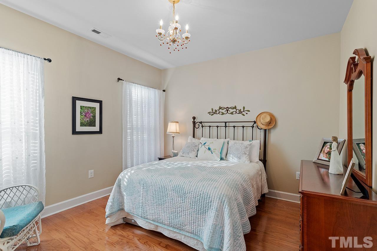 113 Beckingham Loop Cary, NC 27519 - Photo 31 of 46 a bedroom with a bed and wooden floor