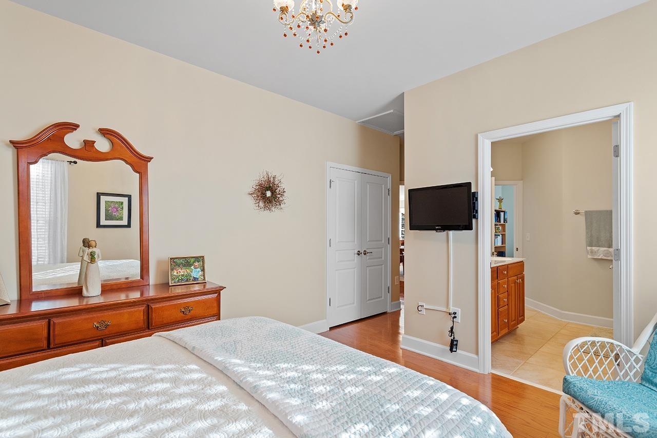 113 Beckingham Loop Cary, NC 27519 - Photo 32 of 46 a bedroom with a bed and a flat screen tv