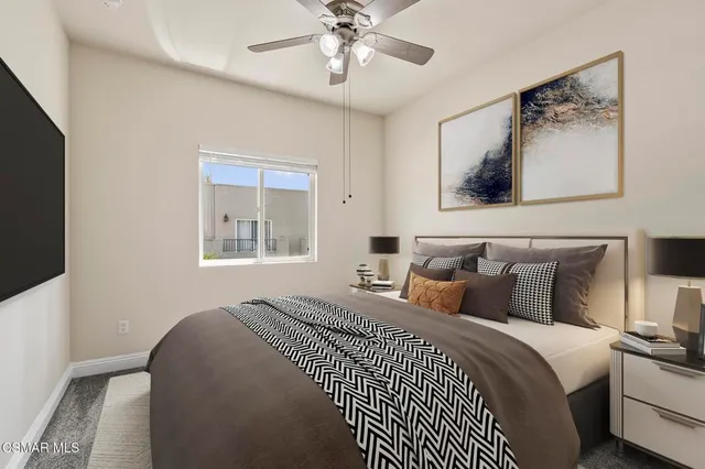 an empty room with closet and a chandelier fan