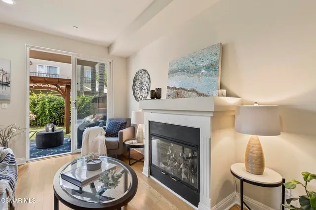 a living room with furniture a fireplace and a table