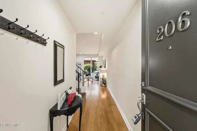 a hallway with a dining table and chairs