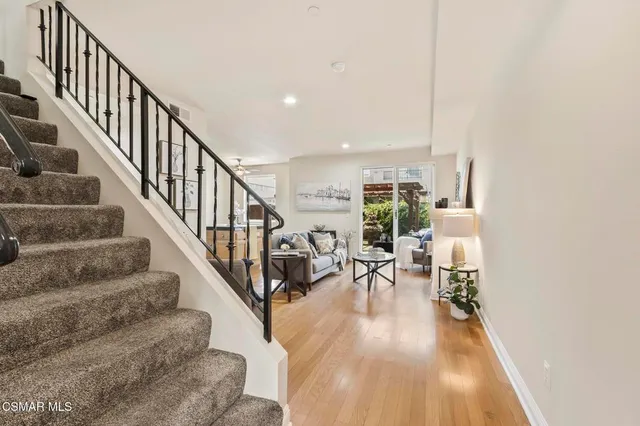 a view of entryway and hall with wooden floor