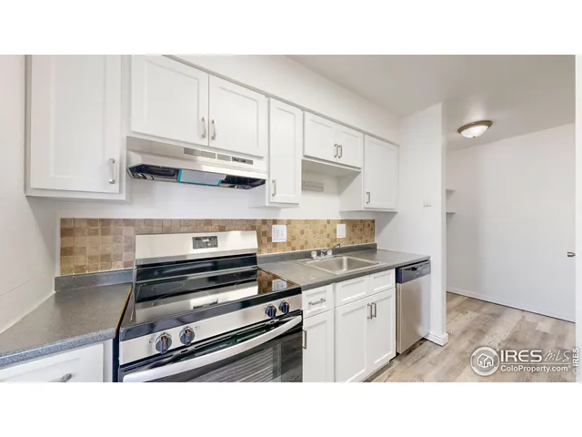 a kitchen with stainless steel appliances a stove and cabinets