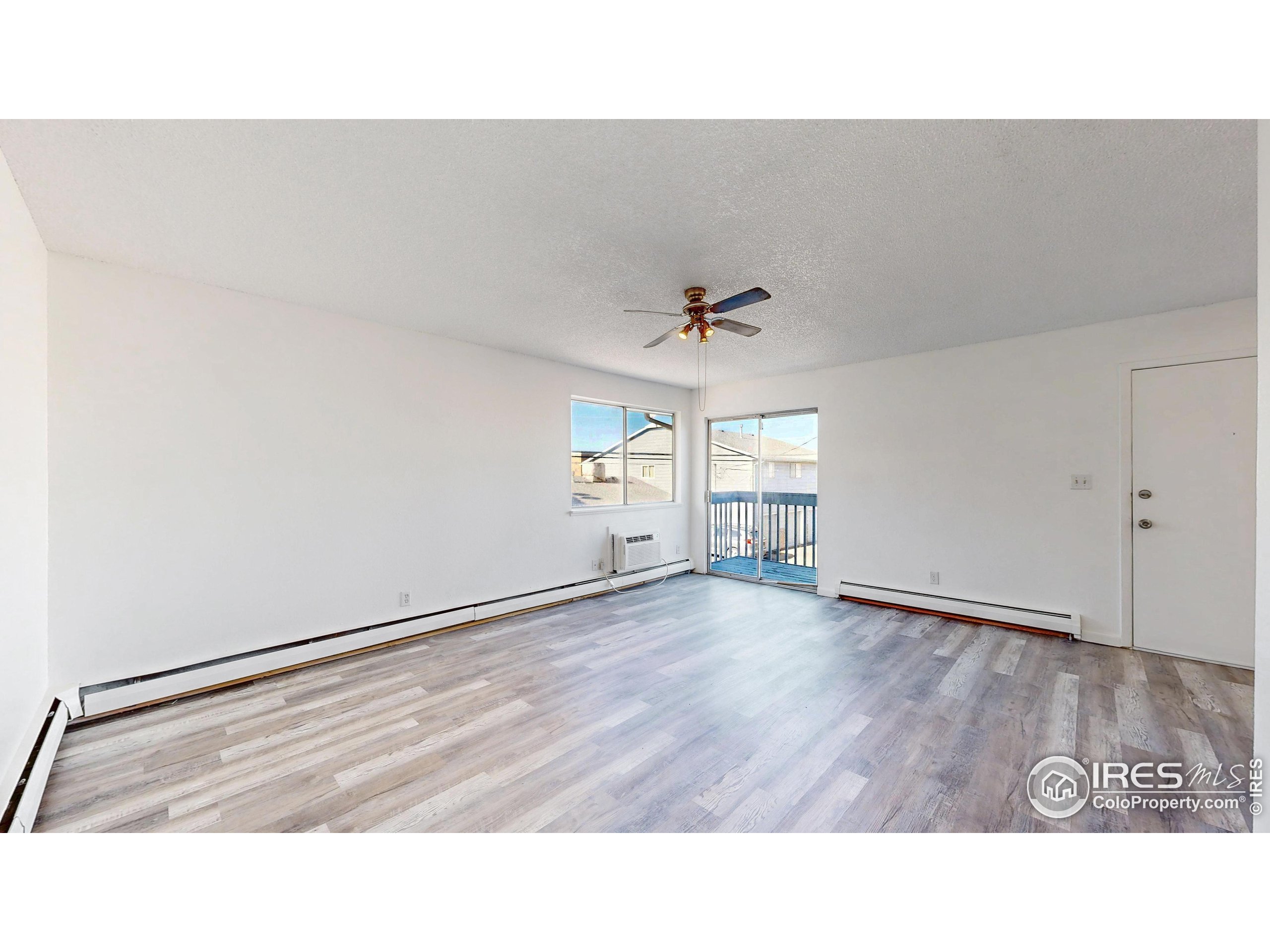 6975 Mariposa Street Denver, CO 80221 - Photo 9 of 34 a picture of an empty room and window