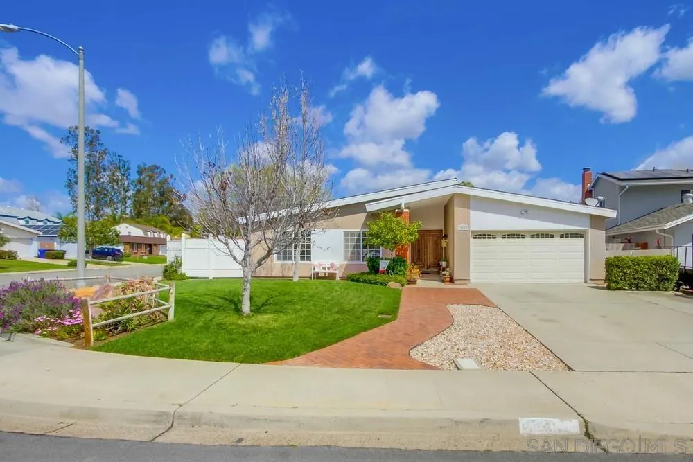a front view of a house with a yard and a garage