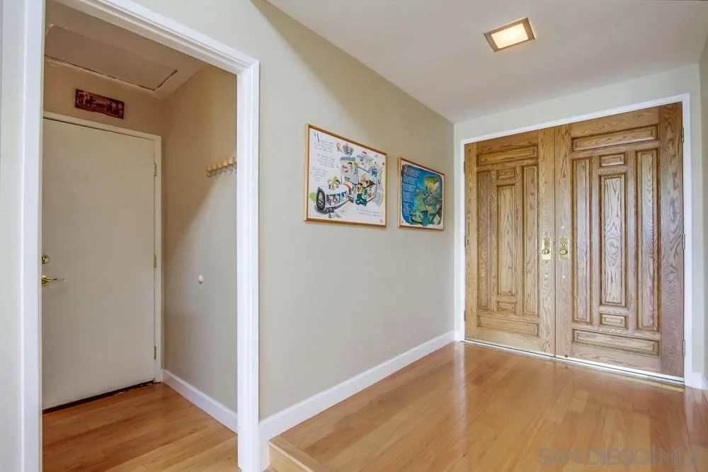 13202 Lingre Avenue Poway, CA 92064 - Photo 11 of 71 a view of an empty room with wooden floor and a window