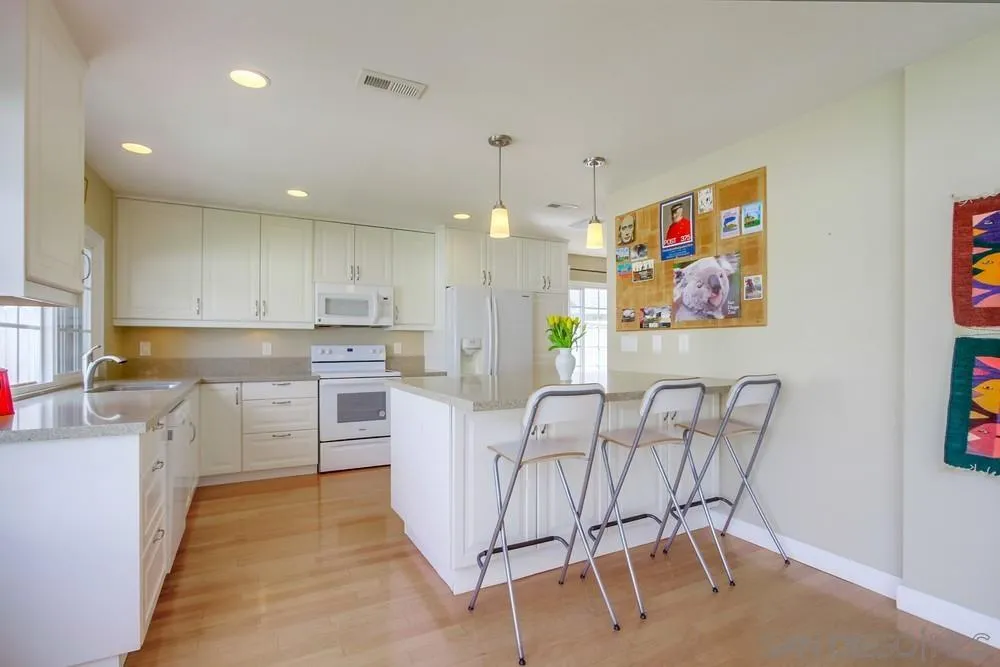 13202 Lingre Avenue Poway, CA 92064 - Photo 32 of 71 a kitchen that has a lot of cabinets in it with appliances and cabinets