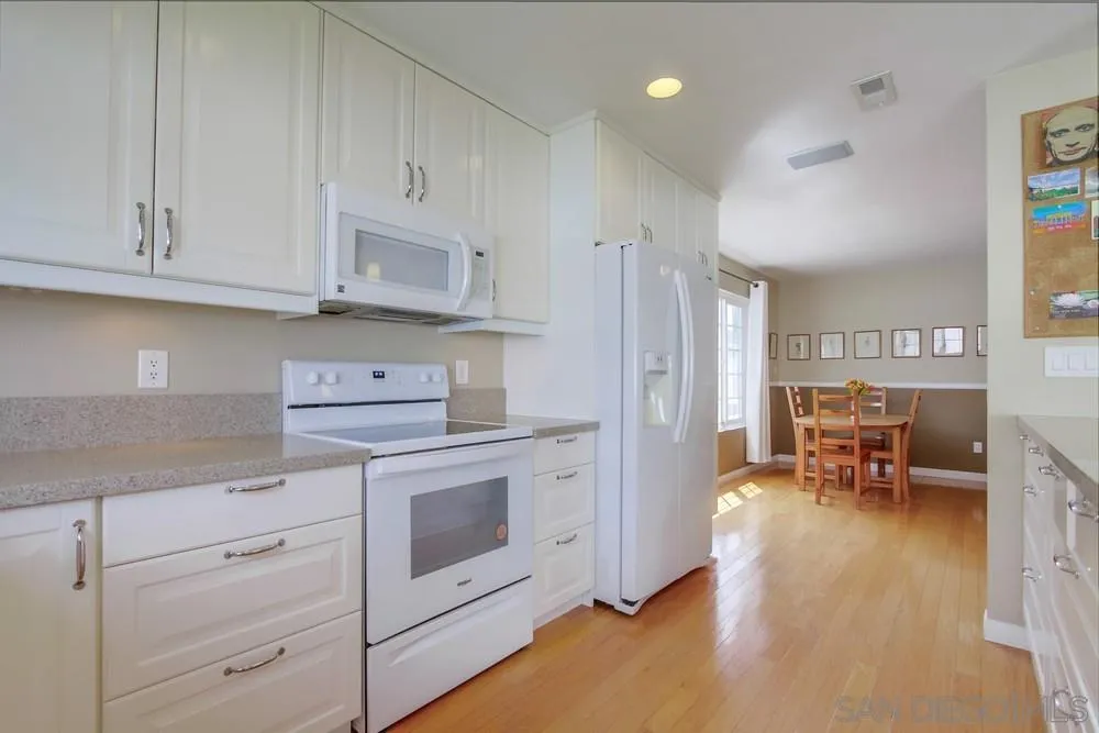 13202 Lingre Avenue Poway, CA 92064 - Photo 33 of 71 a kitchen with stainless steel appliances granite countertop a stove a sink and a refrigerator