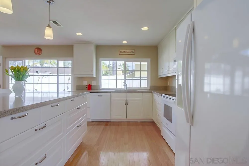 13202 Lingre Avenue Poway, CA 92064 - Photo 35 of 71 a kitchen with granite countertop white cabinets and white appliances