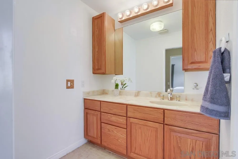 13202 Lingre Avenue Poway, CA 92064 - Photo 41 of 71 a bathroom with a double vanity sink and a mirror