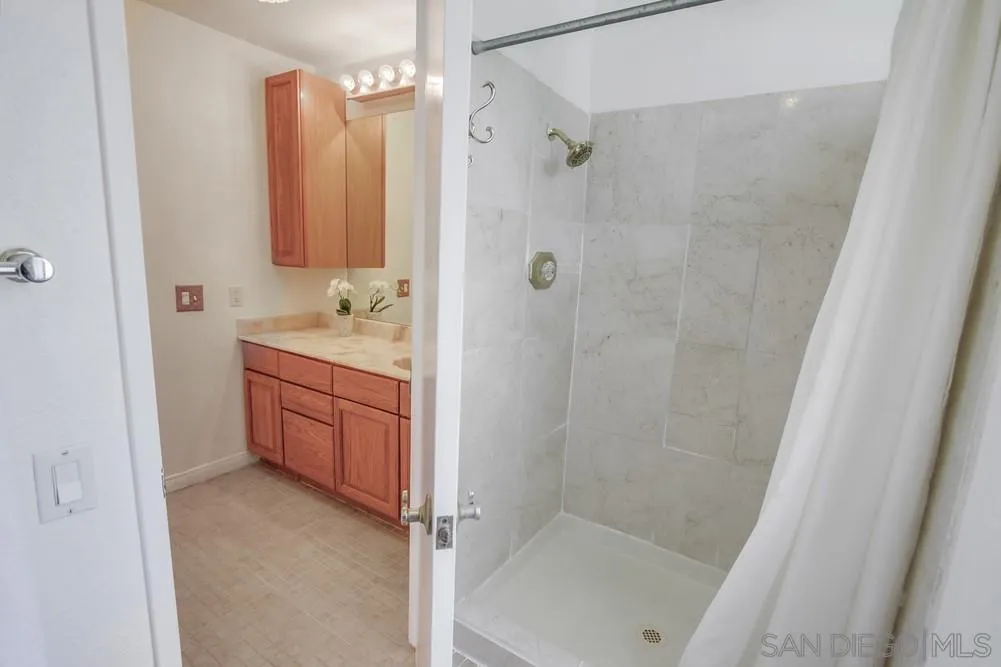 13202 Lingre Avenue Poway, CA 92064 - Photo 43 of 71 a bathroom with a tub a sink a vanity and a shower